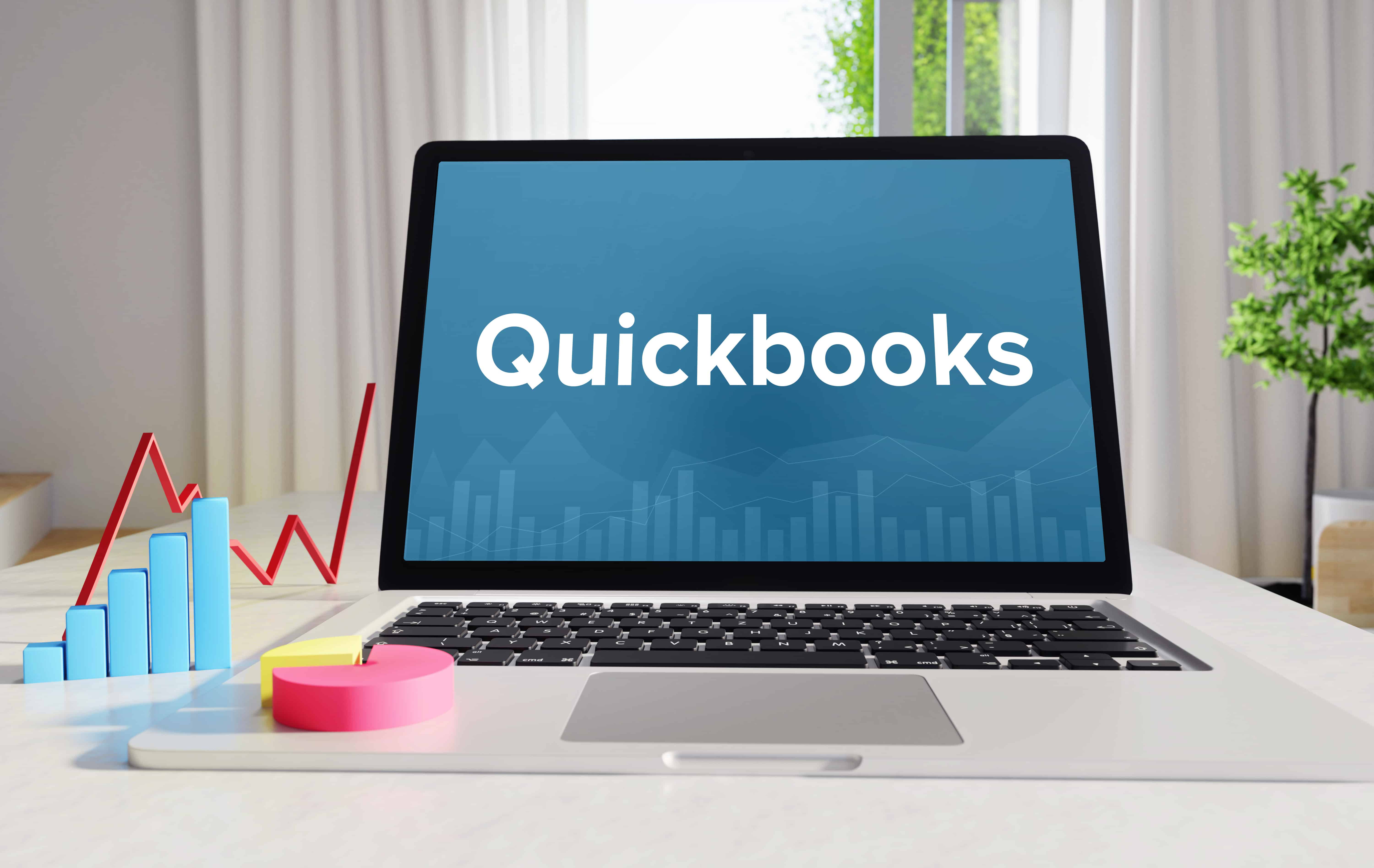 Quickbooks – Statistics/Business. Laptop in the office with term on the display. Finance/Economics.